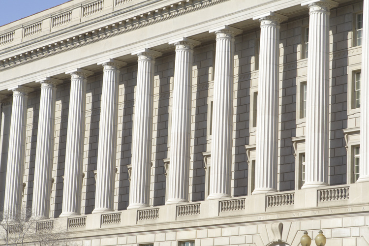 The exterior of a government building with grandiose columns