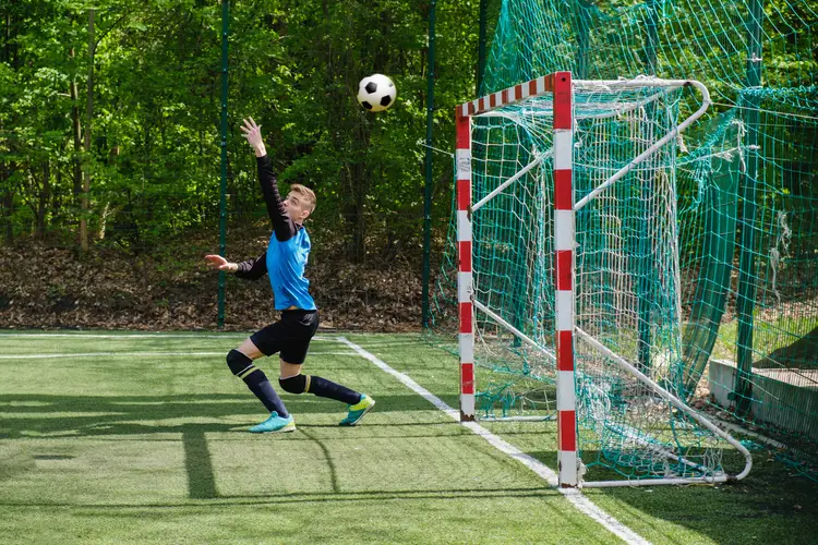 Soccer goalie misses the ball